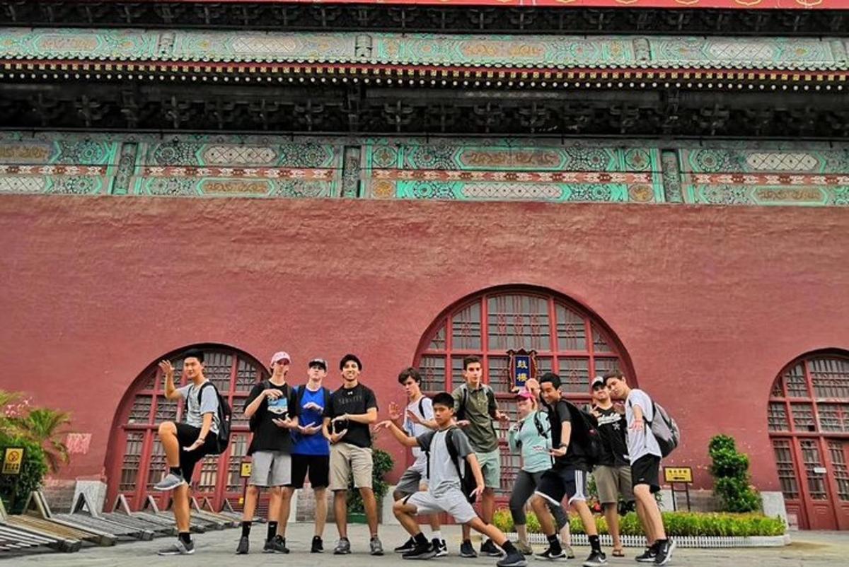 a group of people standing in front of a red building