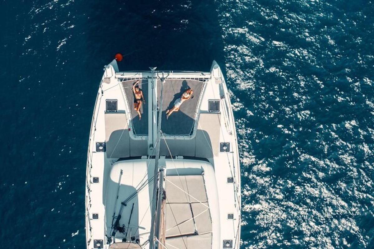 two people sitting on a boat in the water