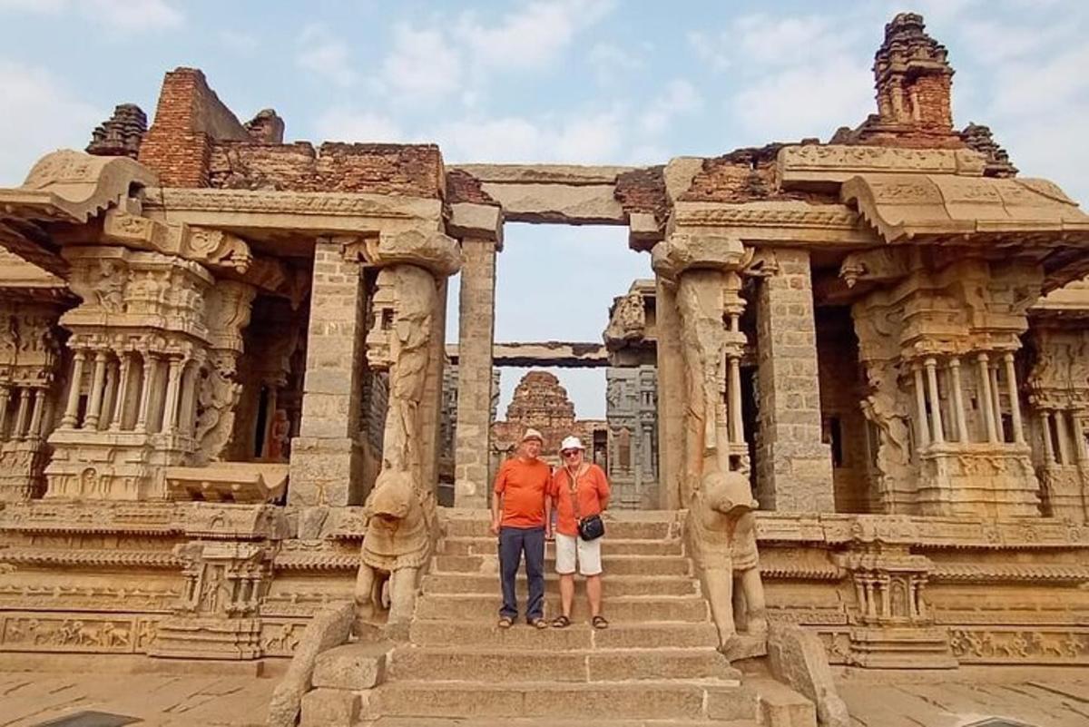two people standing in front of a stone building
