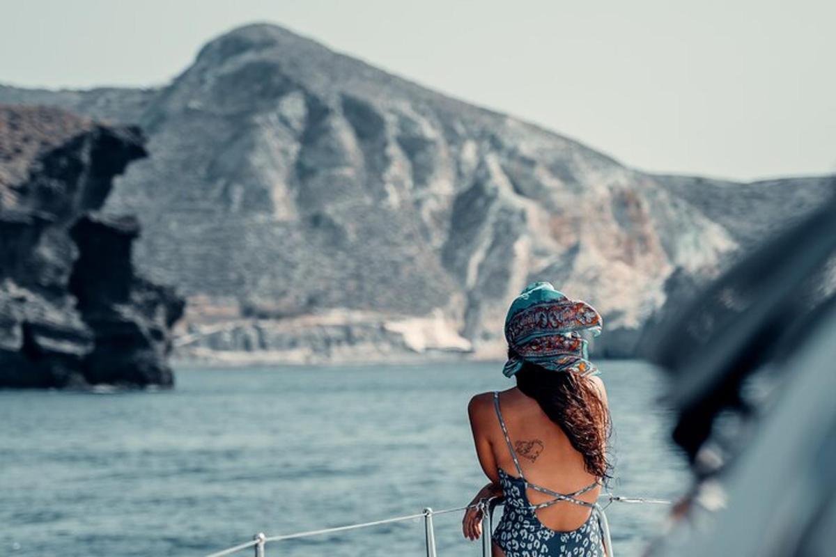 a woman standing on a boat looking at the water