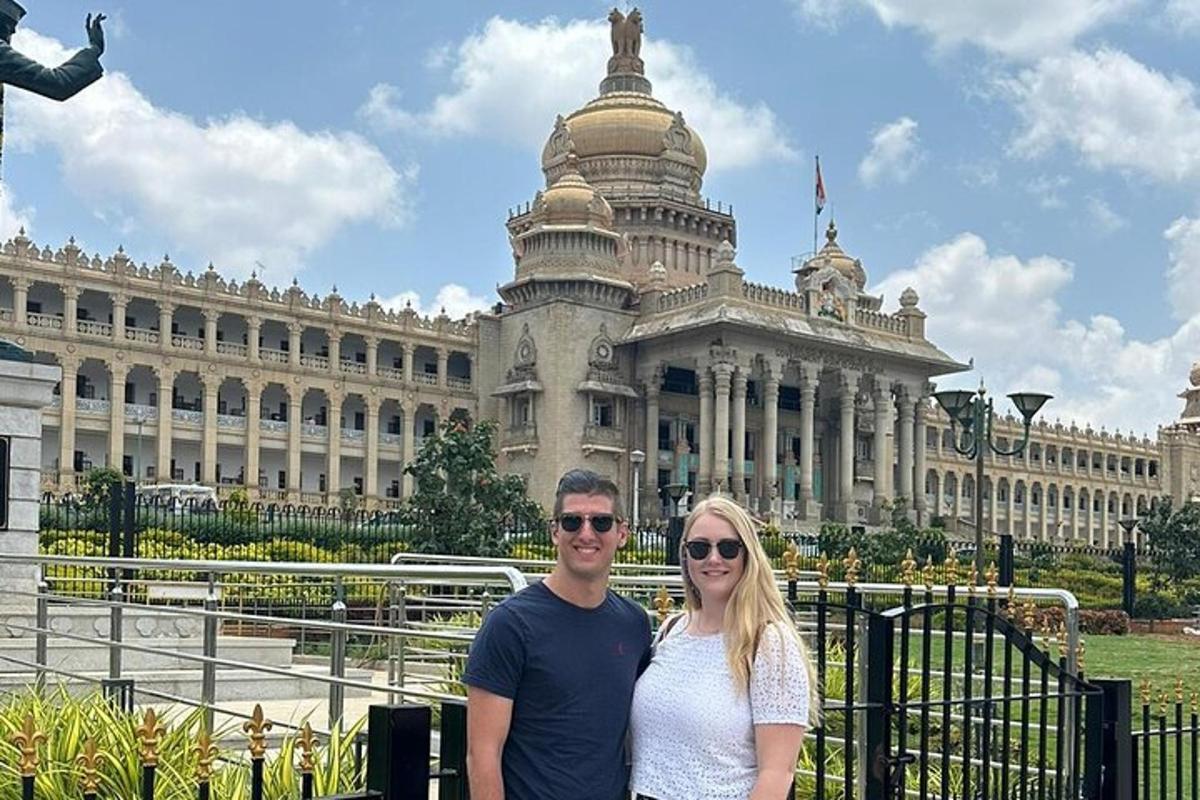 a man and woman standing in front of a building