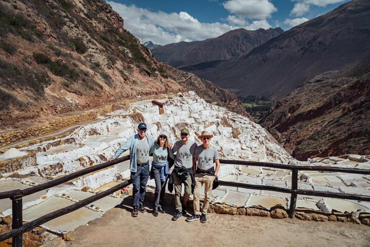 a group of four people standing on a mountain