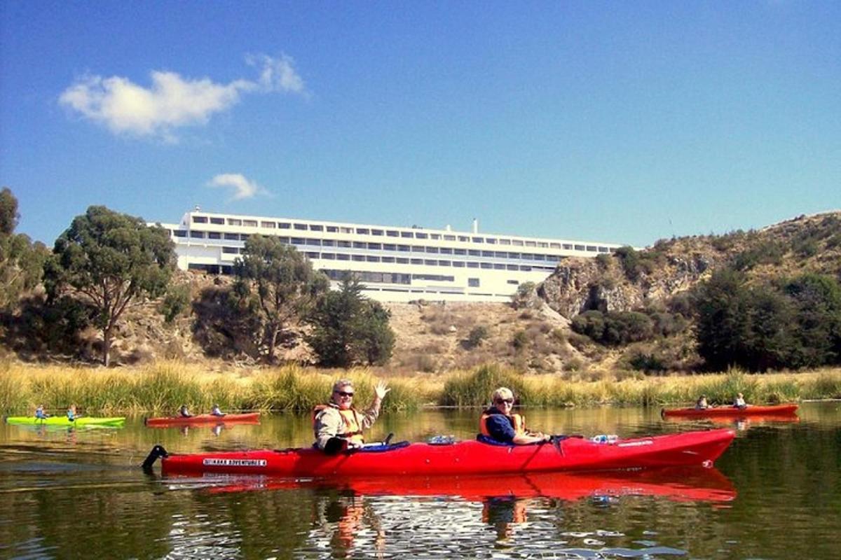two people in a red kayak in the water