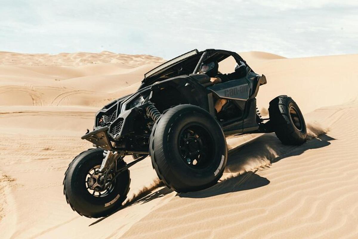 a jeep driving in the sand in the desert