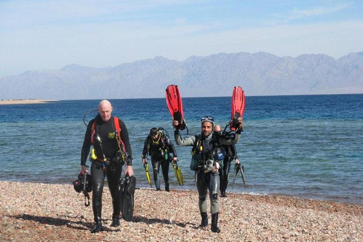 a group of people standing on the beach
