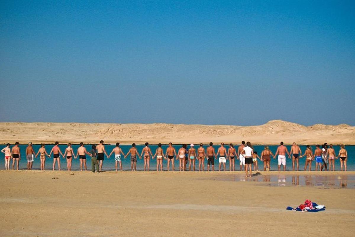 a group of people standing on the beach
