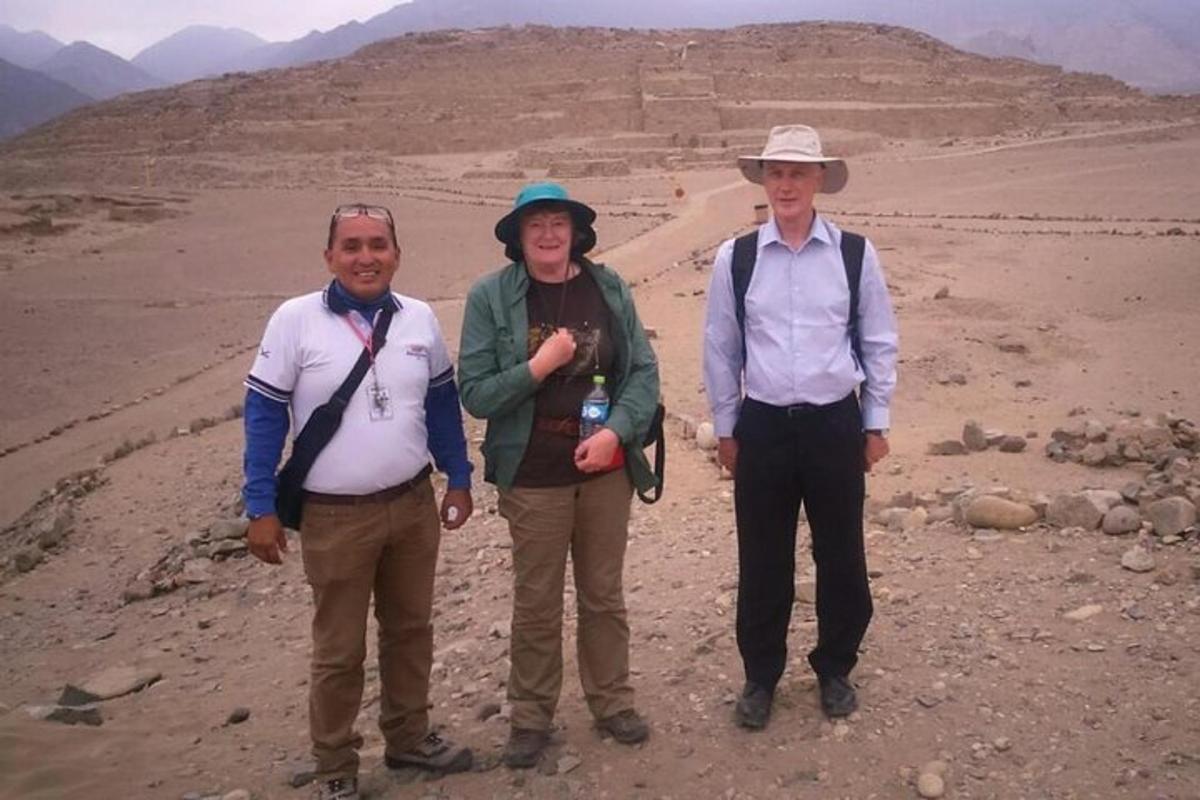a group of three people standing in the desert