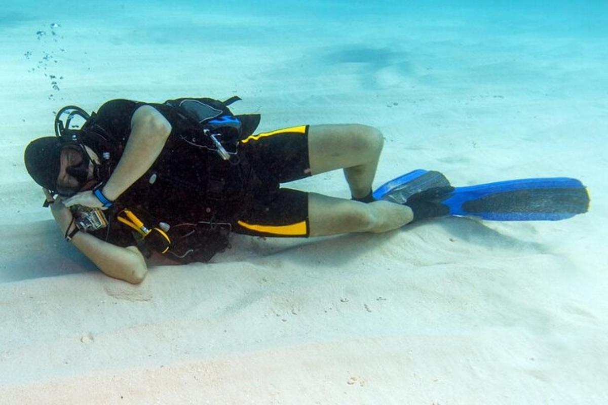 a person laying on the ground in the water