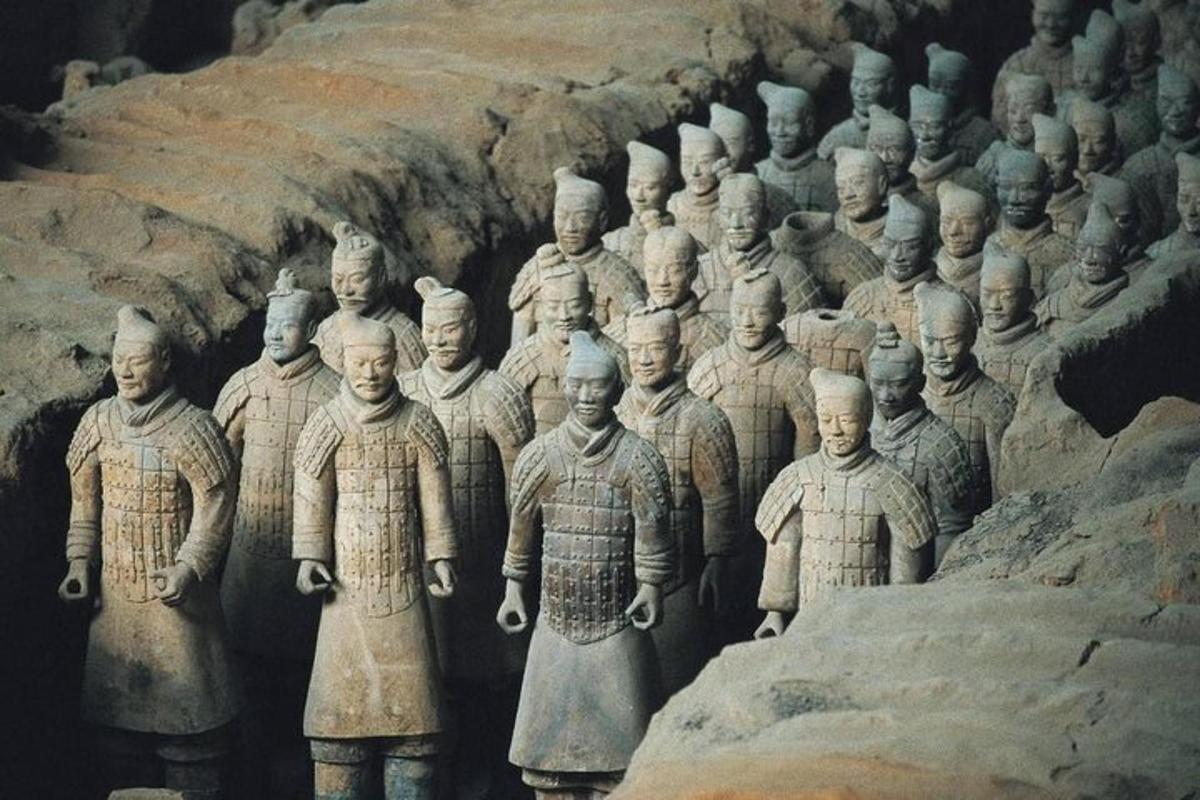 a large group of stone statues in a cave
