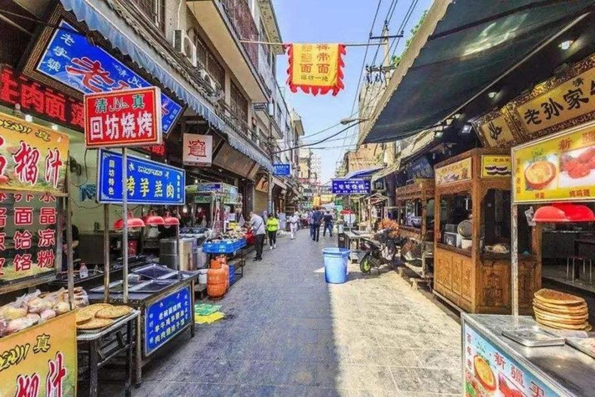 a street with shops and signs in an asian market