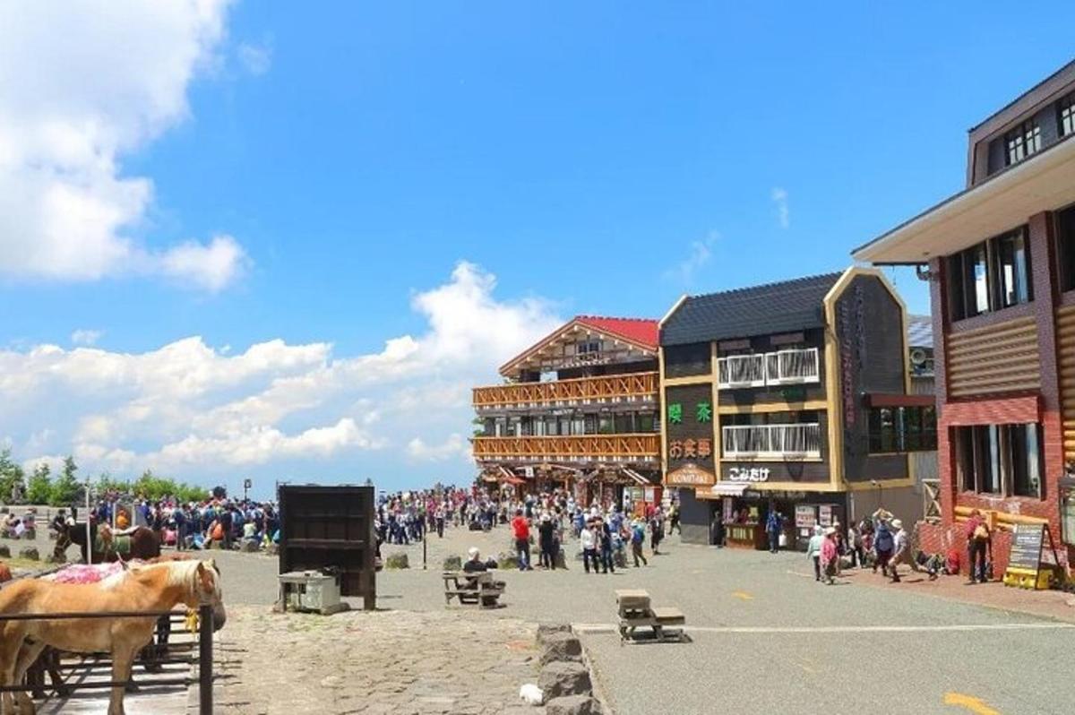 a large crowd of people in a town with buildings