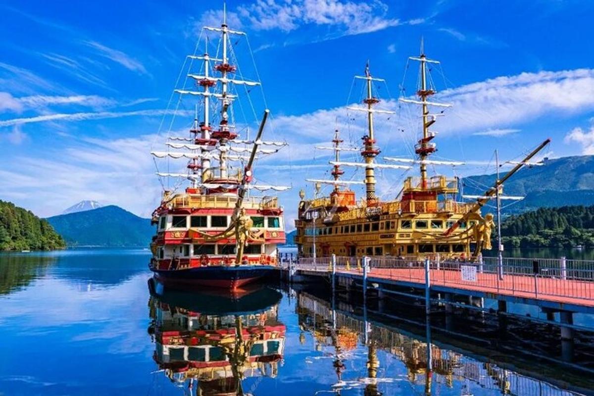 two tall ships docked at a dock in the water