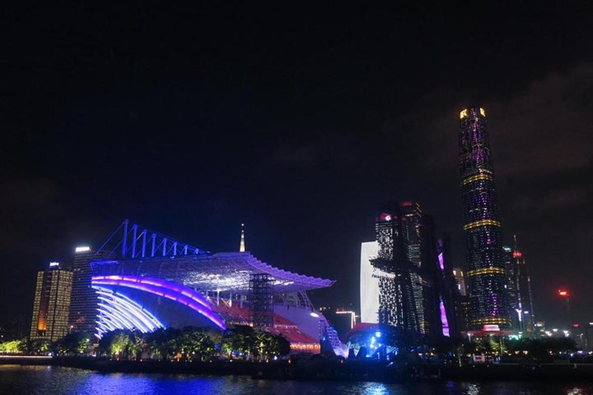 a city lit up at night with tall buildings