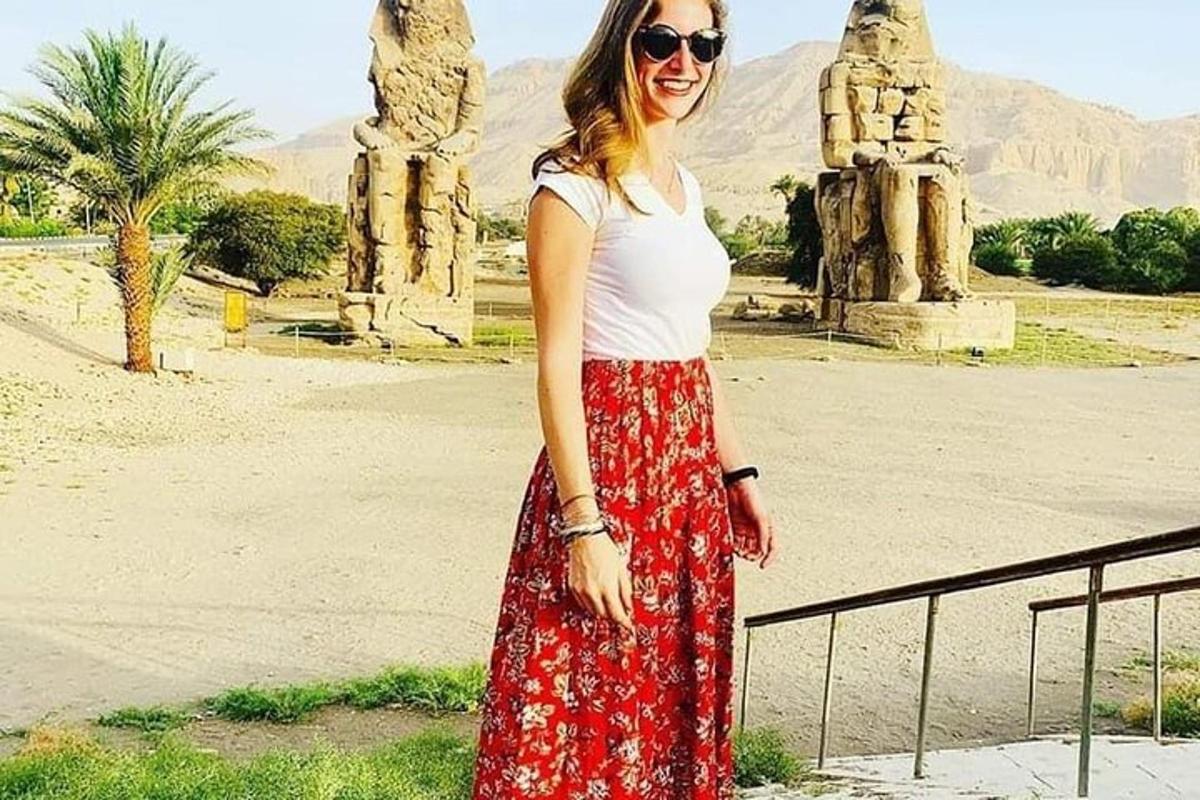 a woman standing in front of a statue