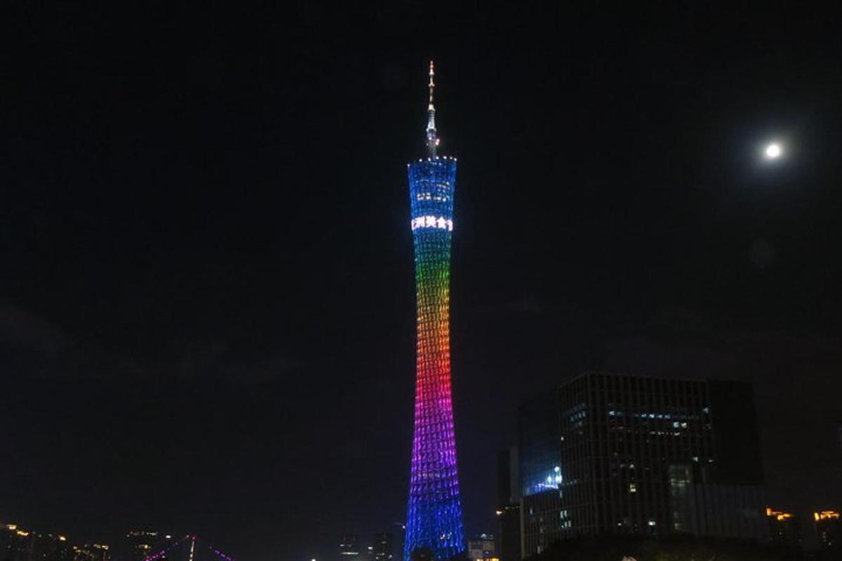 a tall tower lit up in rainbow colors at night