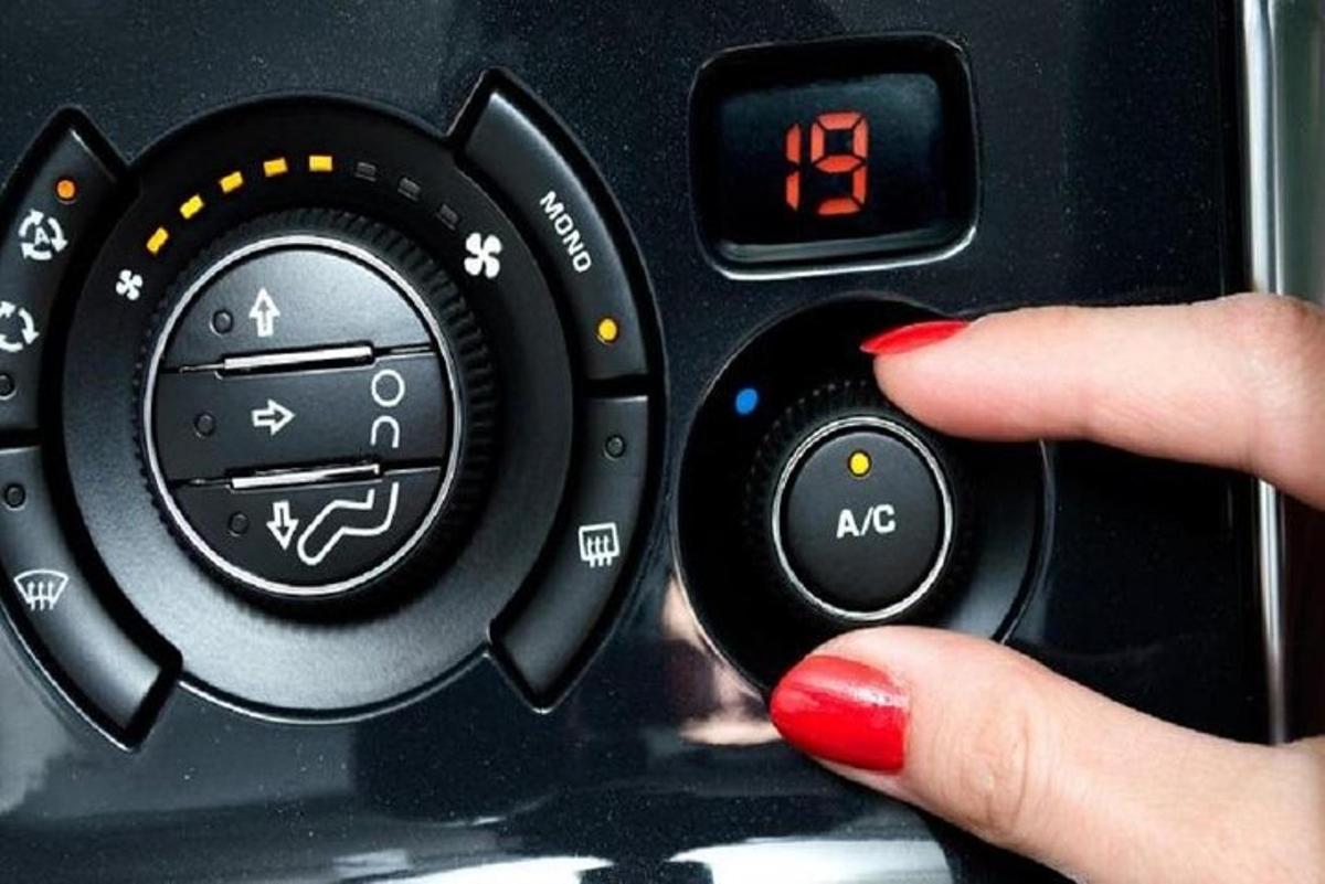 a person holding a remote control with their hand