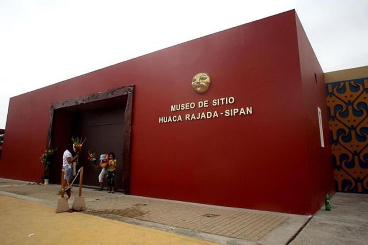 a red building with people standing outside of it