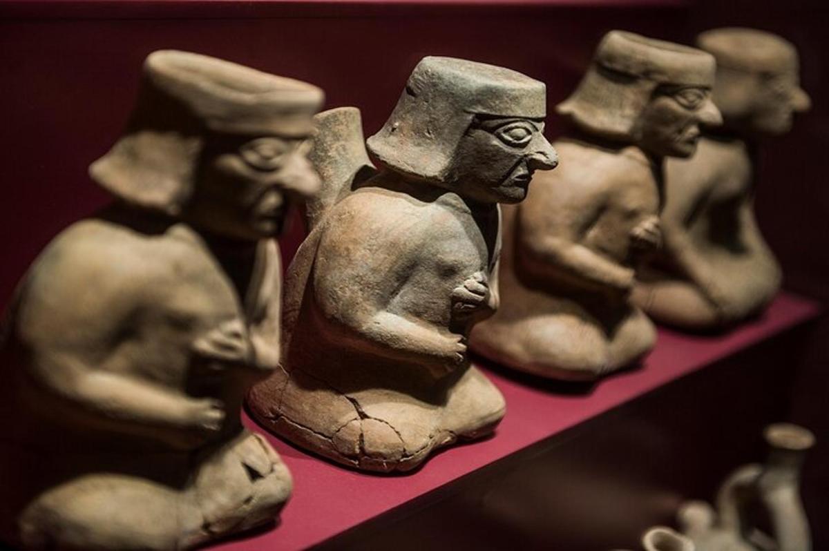 a group of ceramic figurines sitting on a shelf