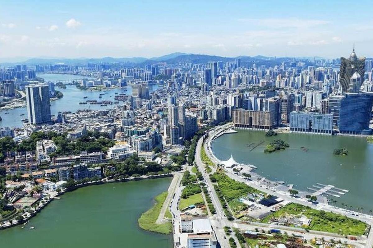 an aerial view of a city with a river and buildings