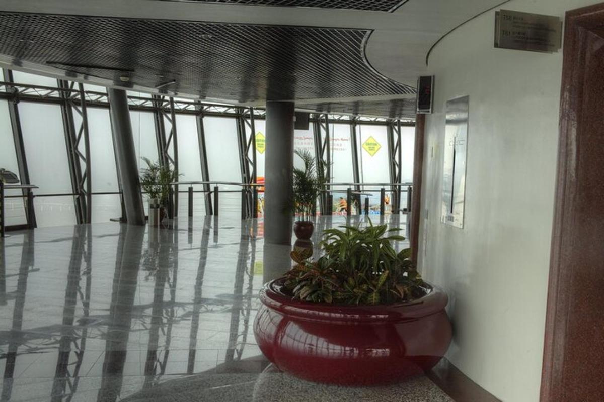 a building hallway with a large pot with plants in it