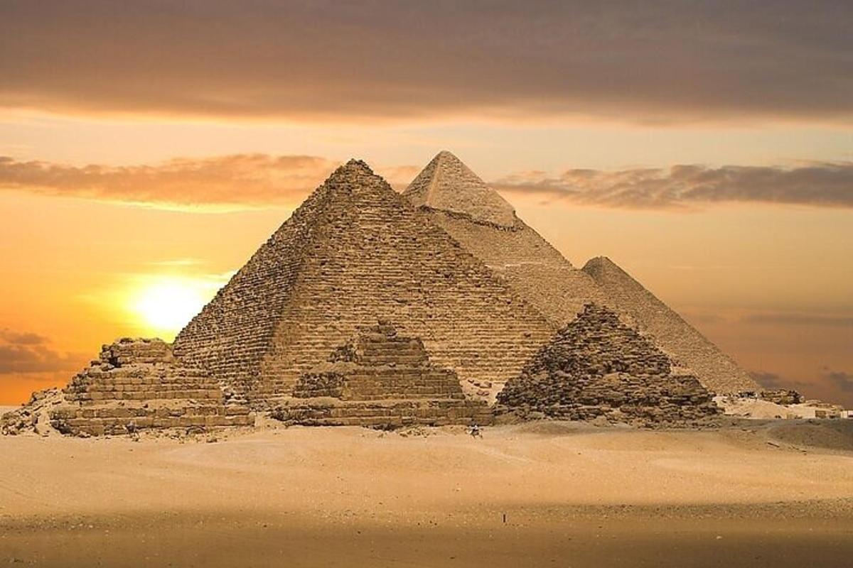 Skupina pyramid v poušti při západu slunce