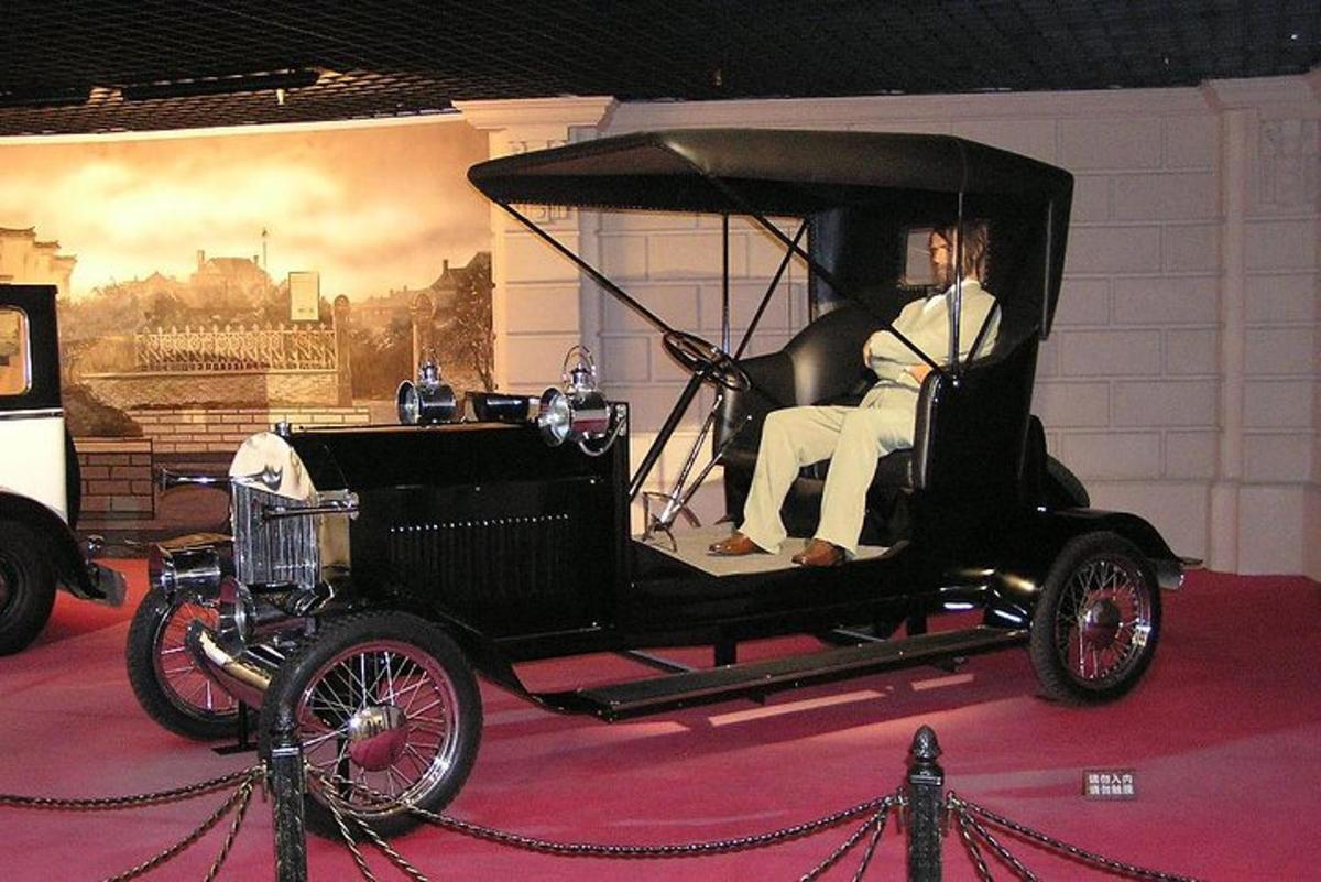 an old car is on display in a museum