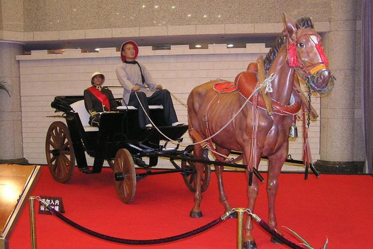 a man riding in a horse drawn carriage