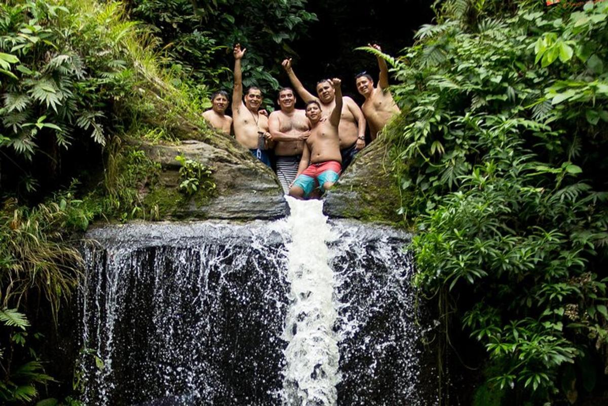 a group of men standing on top of a waterfall