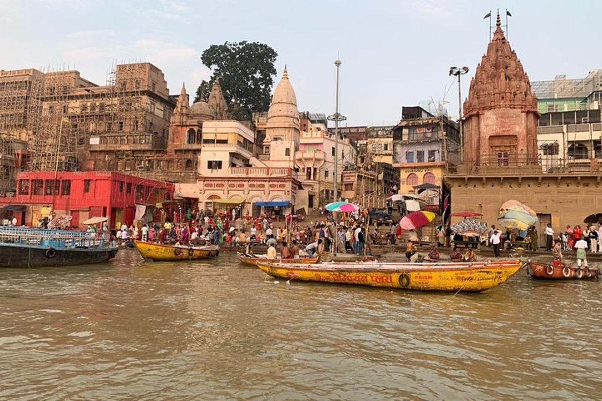 a group of people in boats on a river with buildings