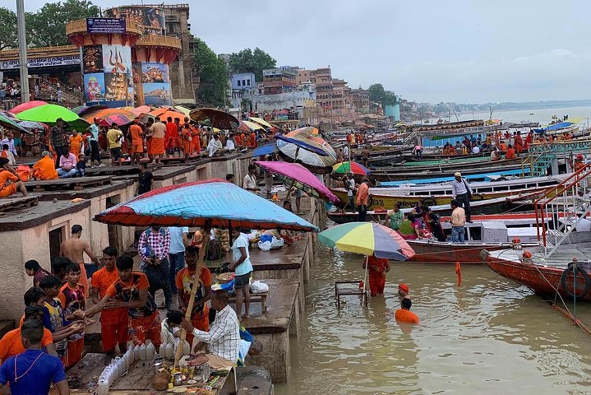 a group of people standing in the water with umbrellas