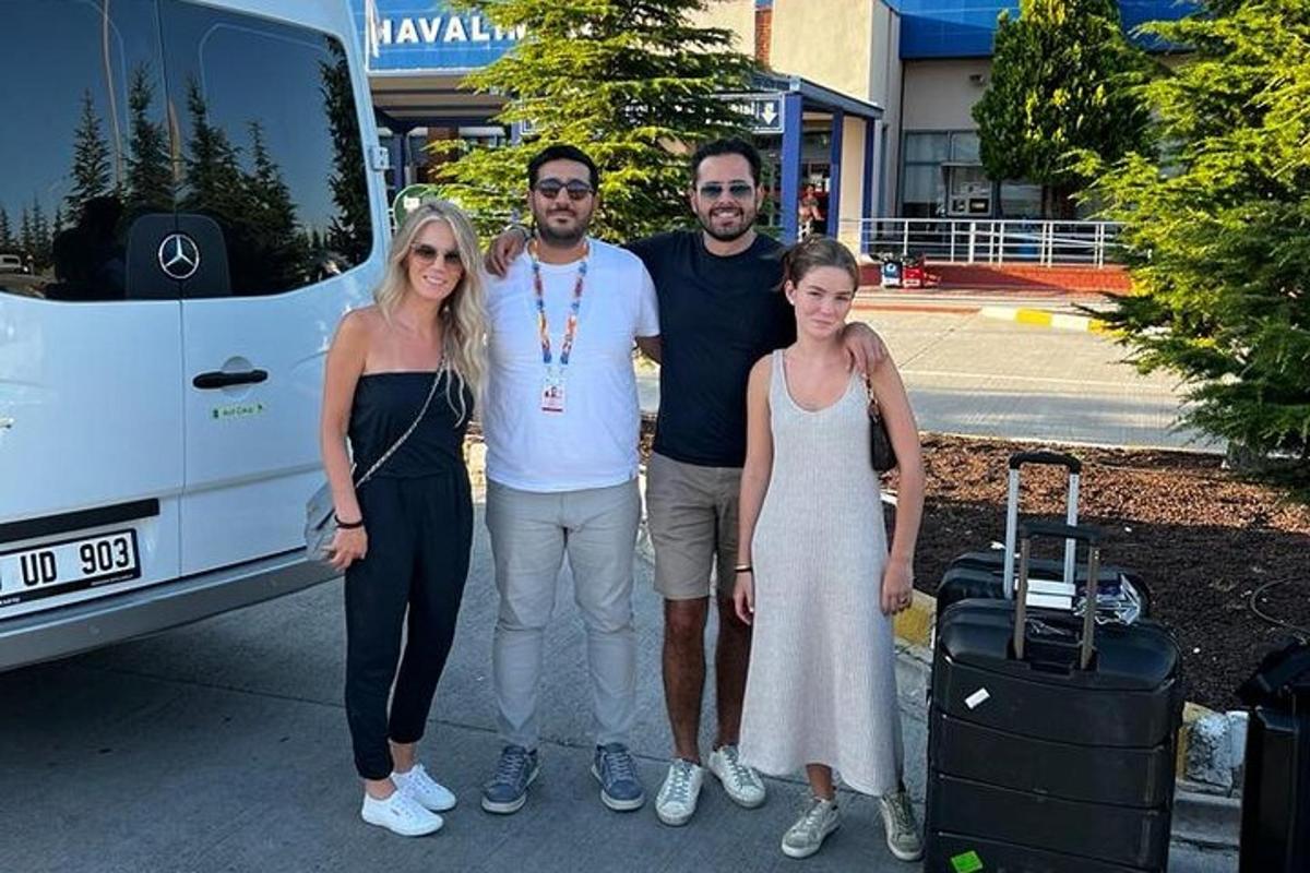 a group of people standing in front of a bus