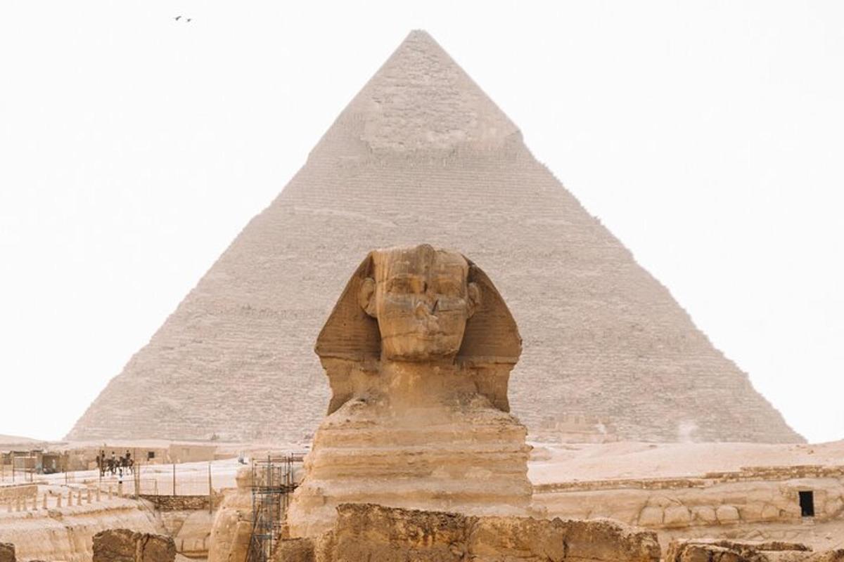 a statue in front of the pyramid