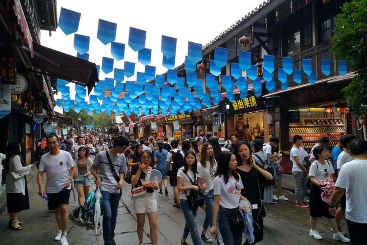 a crowd of people walking down a busy street