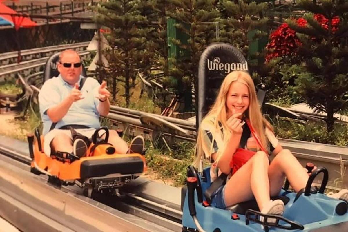 a man and a woman riding on a roller coaster