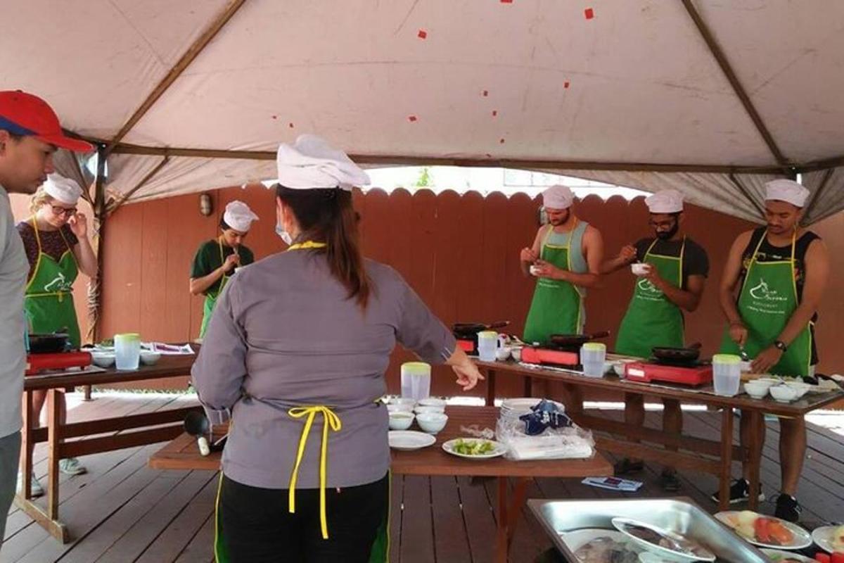 a group of people in a tent preparing food
