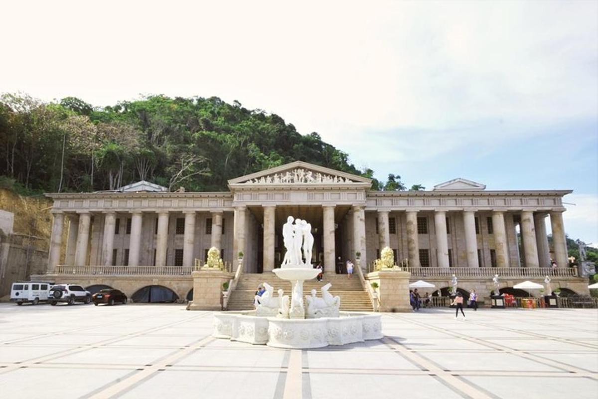 a large building with a statue in front of it