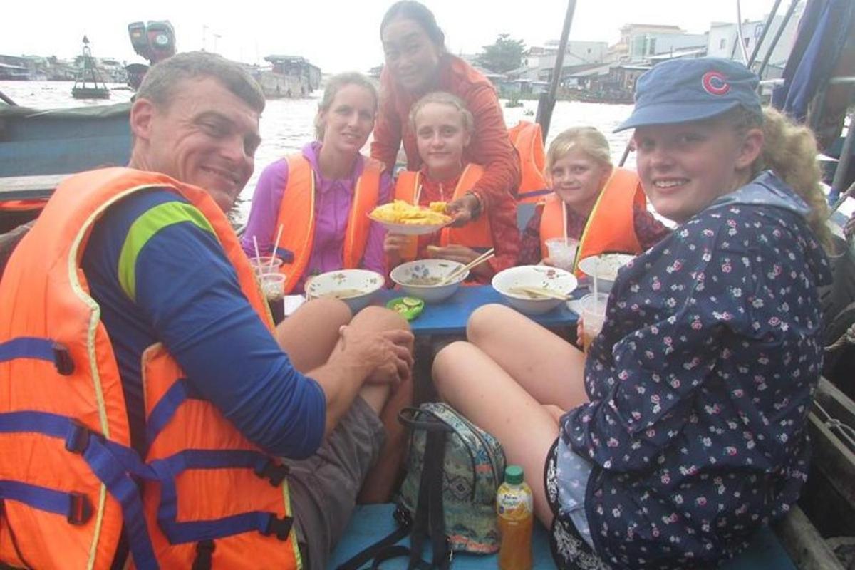 a group of people in life jackets on a boat