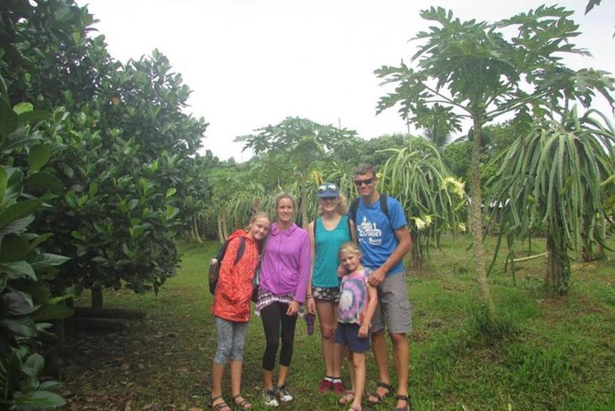 a family poses for a picture in front of a tree