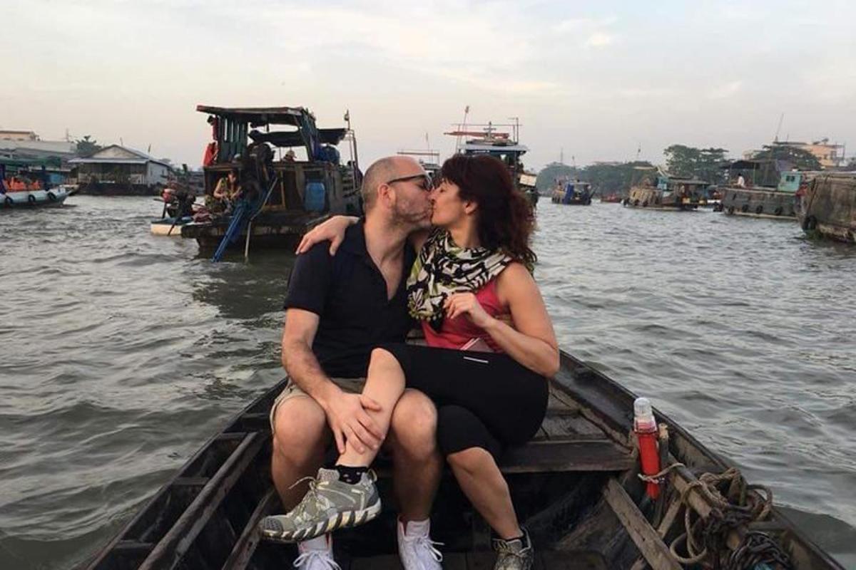 a man and woman sitting on a boat in the water