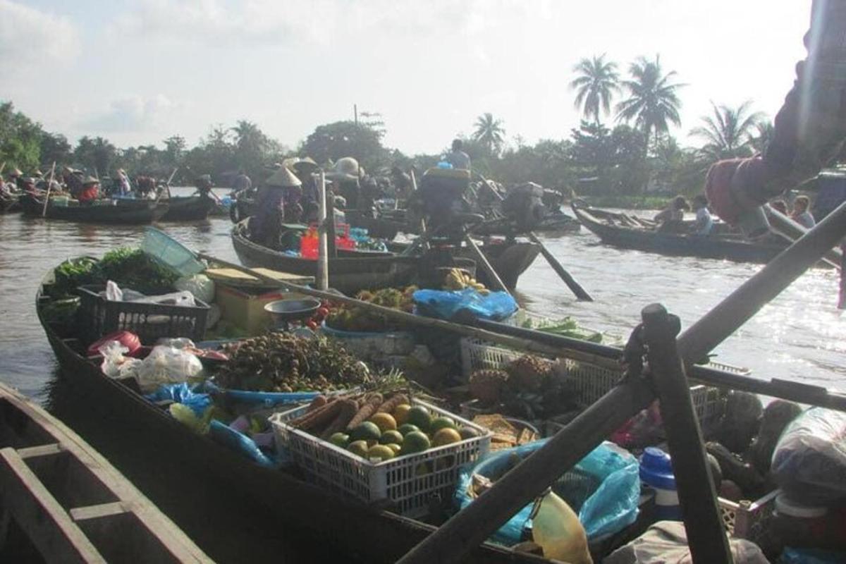 a boat filled with fruits and vegetables on the water