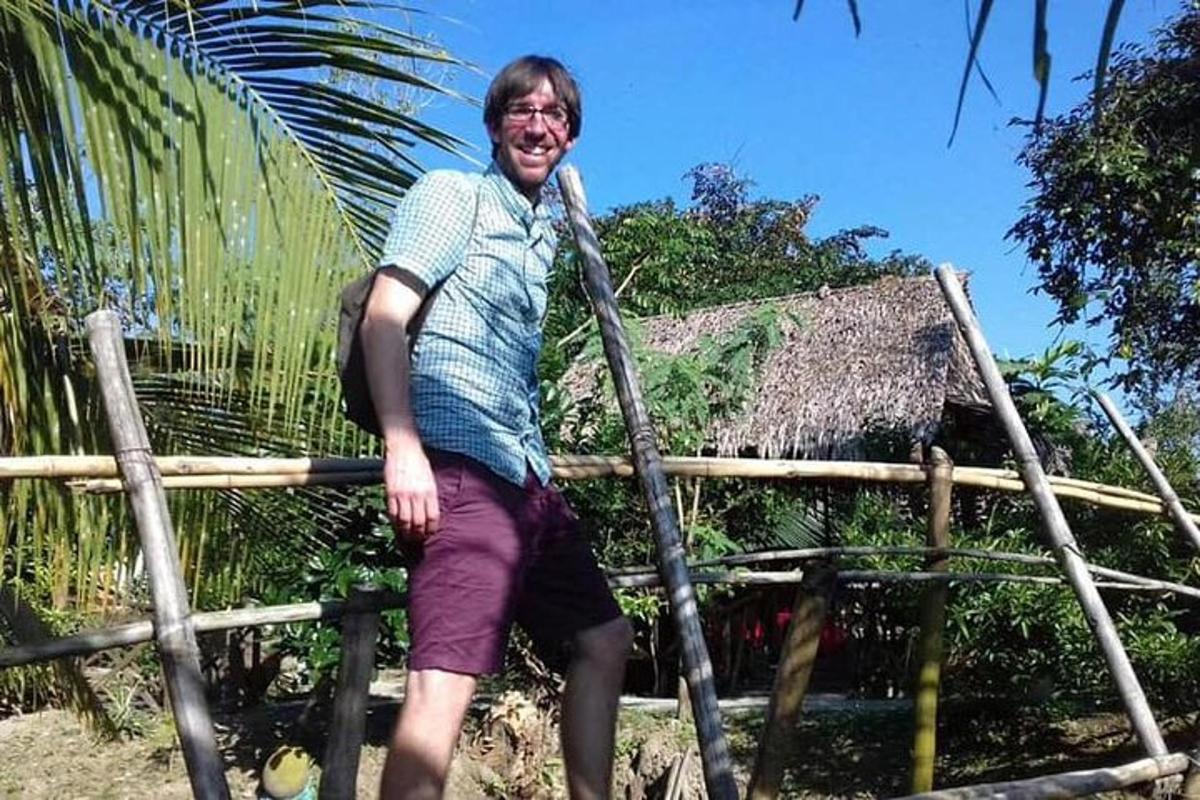 a man is standing on a rope bridge