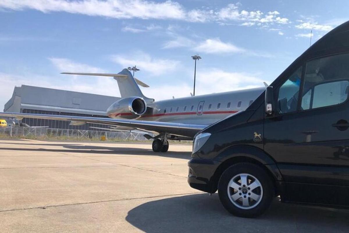 a van parked in front of an airplane