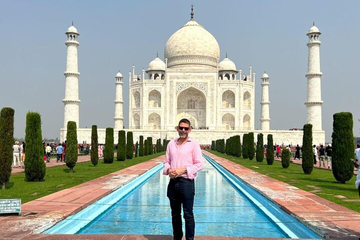 a man standing in front of the taj mahal