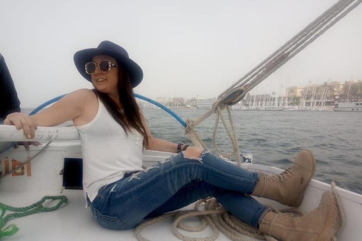 a woman in a hat sitting on a boat