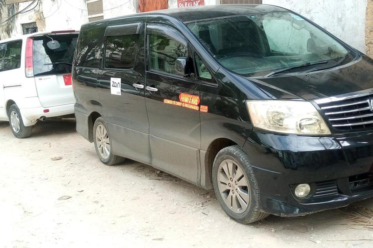 a black van parked next to a white van
