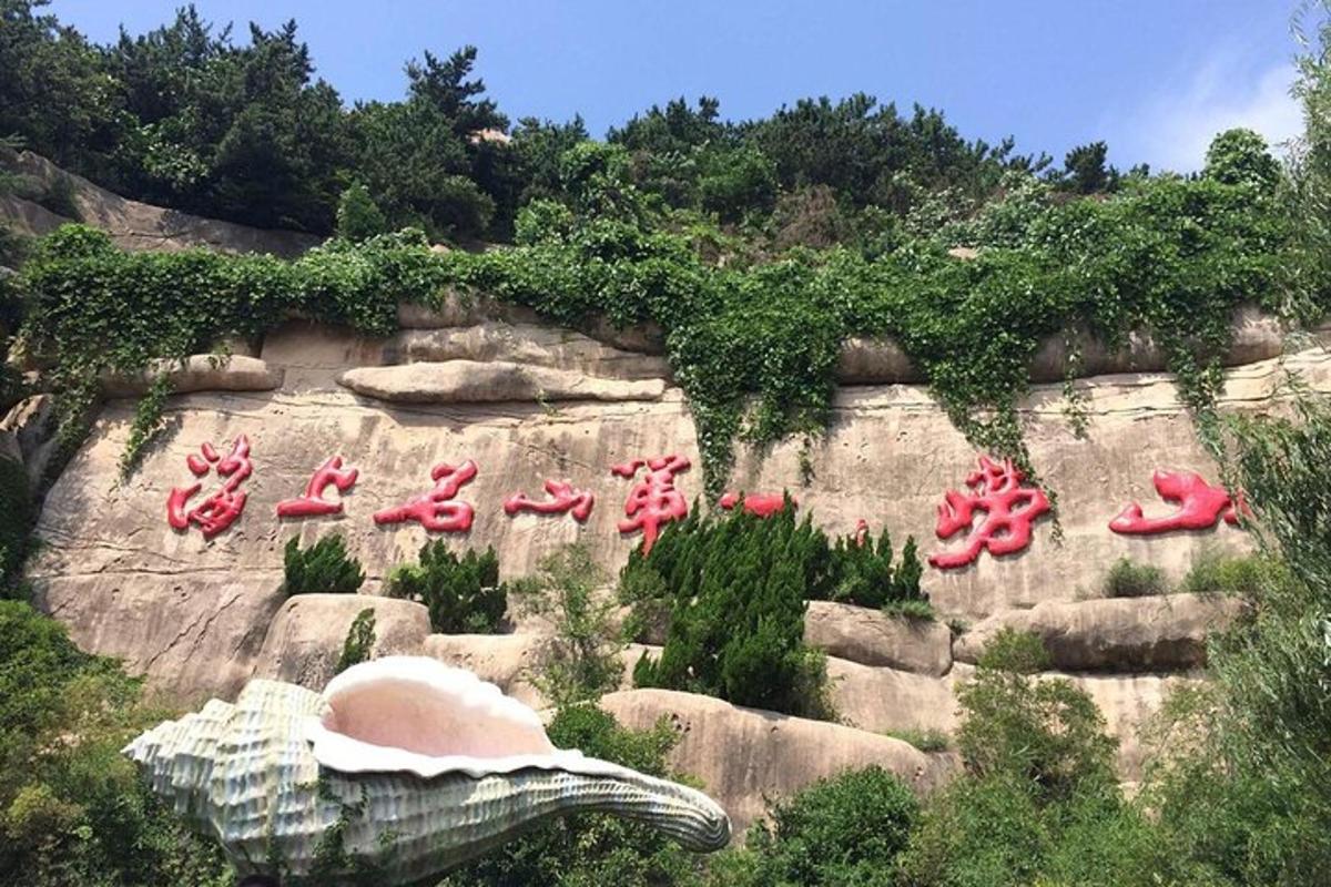 a bunch of red shoes on a rock wall