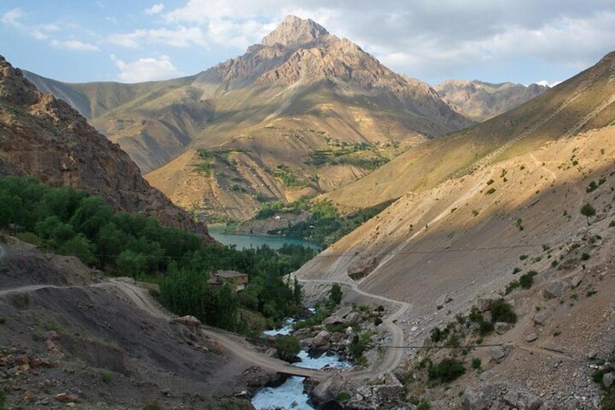 a view of a mountain with a river in a valley