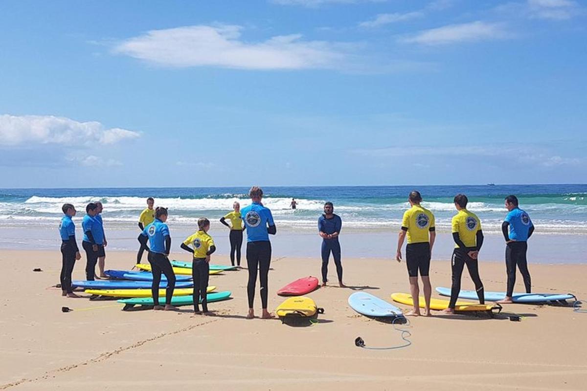a group of people standing on a beach with surfboards