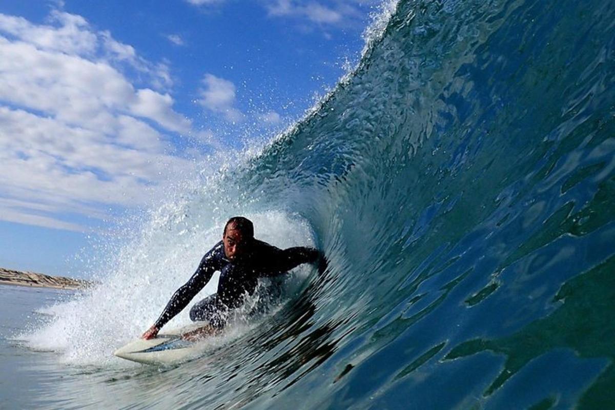 a man riding a wave on a surfboard in the ocean