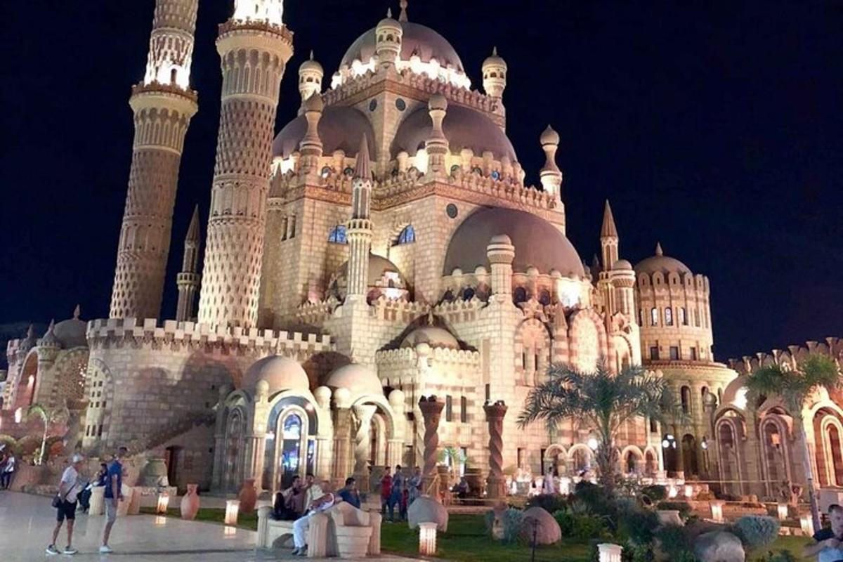 a building with people standing outside of it at night
